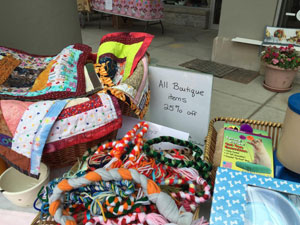 Picture of a table of items for sale at a sidewalk sale.